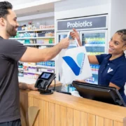 female cashier checks out a male customer at a Vitamin Shoppe location