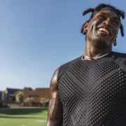 Black man wearing a weighted shirt to work out.