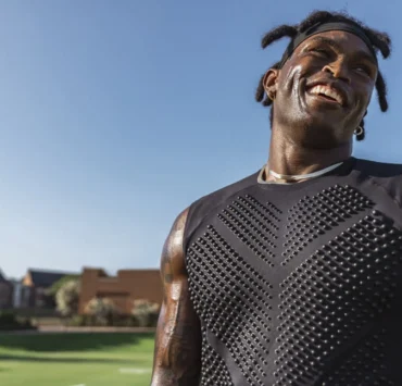 Black man wearing a weighted shirt to work out.