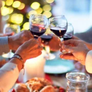 an image of four people toasting together during the holiday season