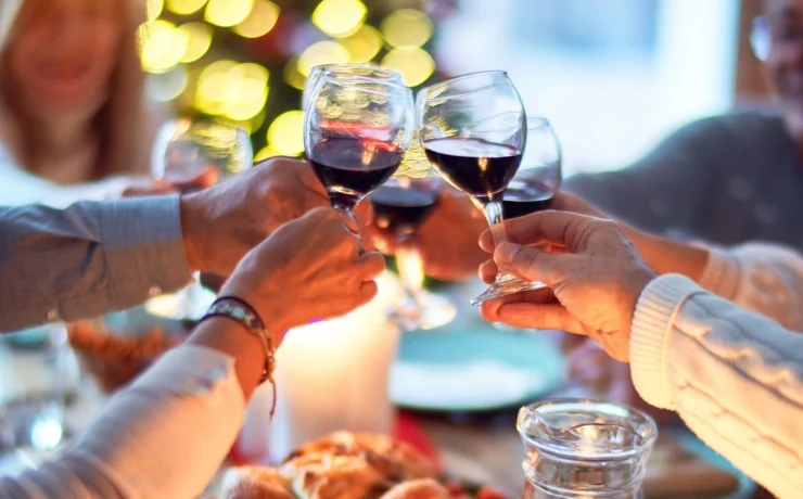 an image of four people toasting together during the holiday season