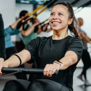 a smiling woman working out at Orangetheory Fitness