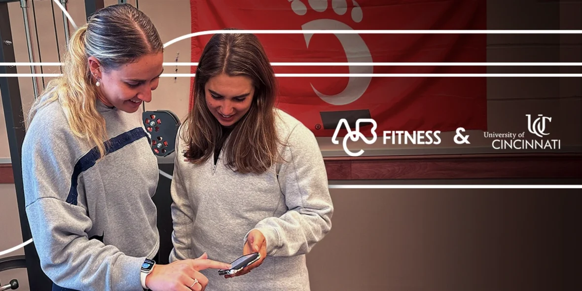 two young woman looking at a phone
