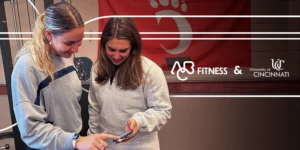 two young woman looking at a phone