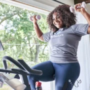 a smiling woman working out on Echelon fitness equipment