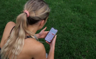 athletic woman looks at her smartphone