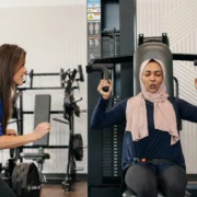 woman works out on a shoulder press machine