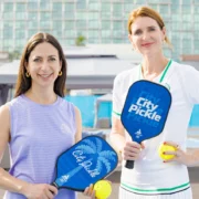 CityPickle founders Erica and Mary holding pickleball paddles