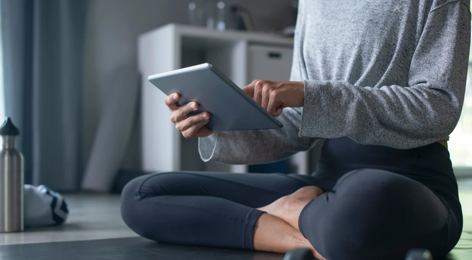 Woman using ipad to exercise