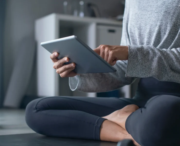 Woman using ipad to exercise