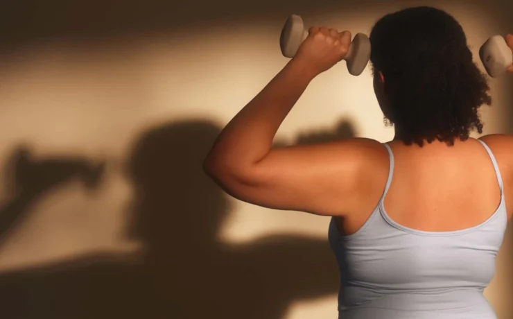 a woman strength training with hand weights