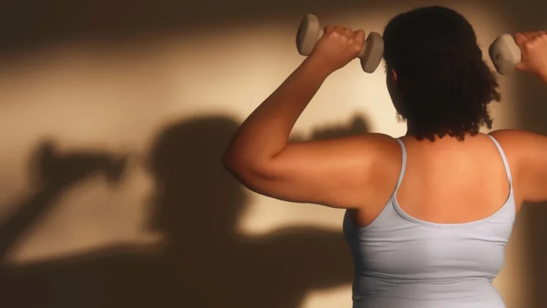 a woman strength training with hand weights