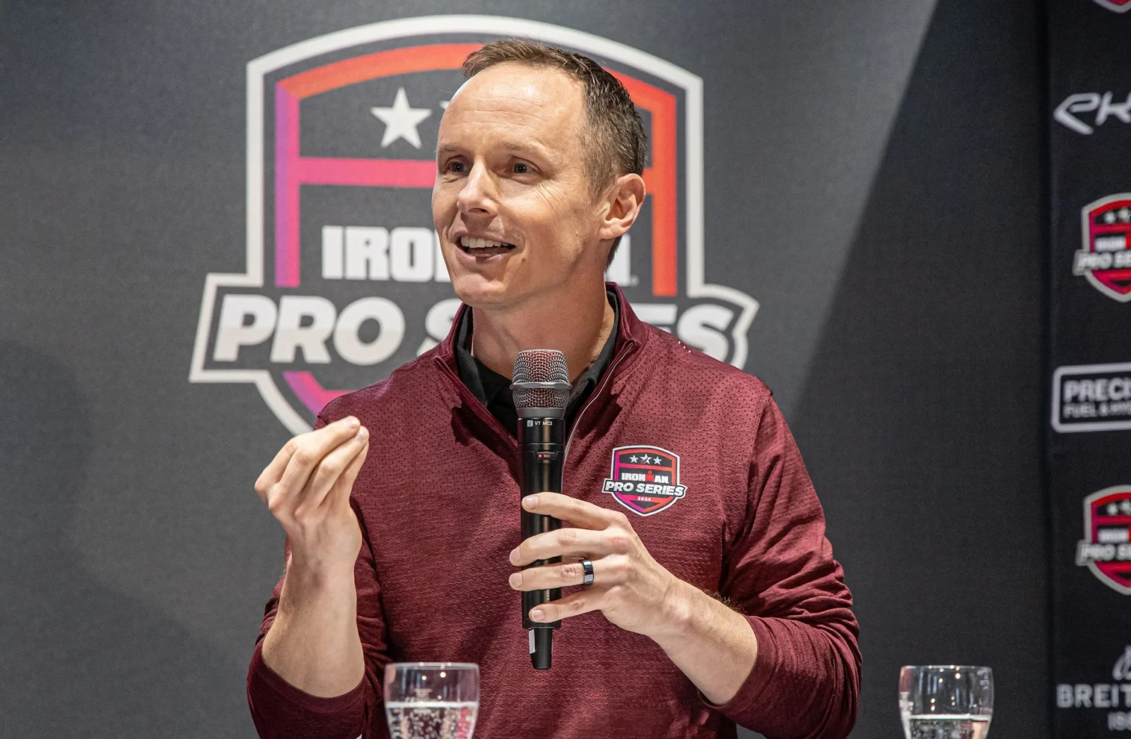 Scott DeRue speaks at an Ironman event