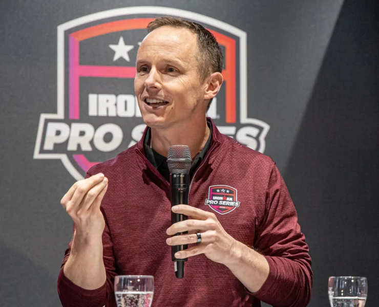 Scott DeRue speaks at an Ironman event