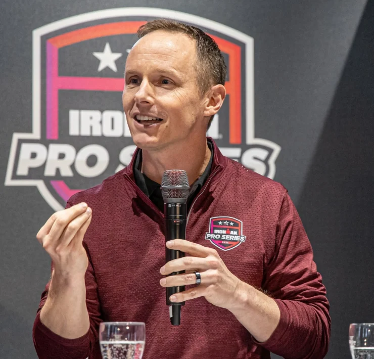 Scott DeRue speaks at an Ironman event