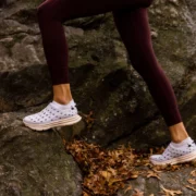 woman runs on a cliff wearing Kane shoes