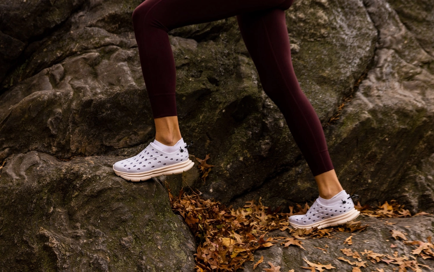 woman runs on a cliff wearing Kane shoes