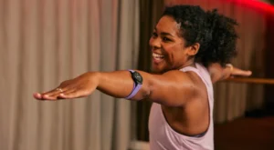 Black woman doing yoga with Myzone watch