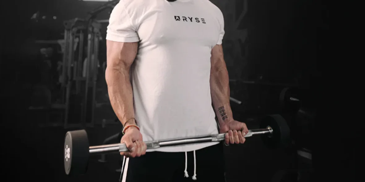 an image of a man wearing a RYSE tee and lifting weights