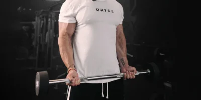 an image of a man wearing a RYSE tee and lifting weights