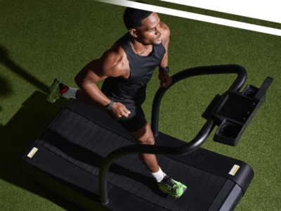 a man running on the Curve, a Woodway treadmill