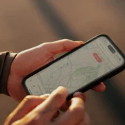 man checks the Strava app on his smartphone