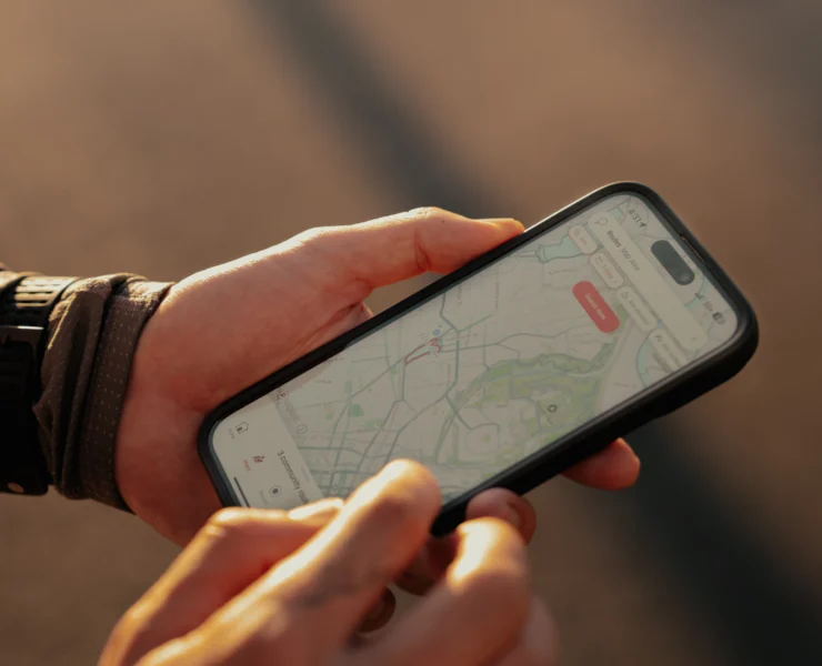 man checks the Strava app on his smartphone