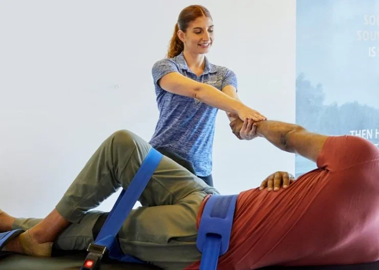 Woman Stretching man at Stretch Zone