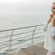 Woman wearing hoodie on pier