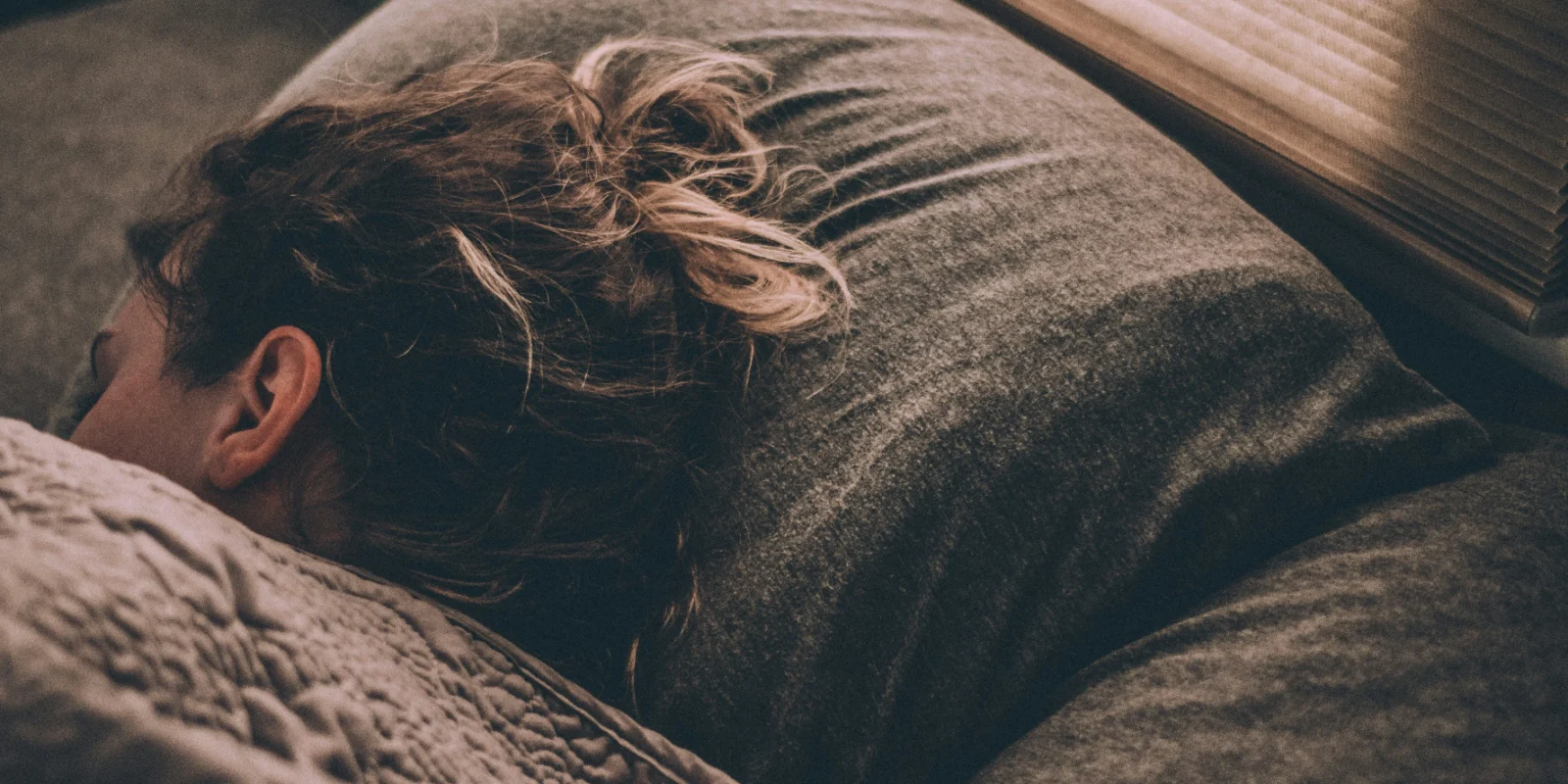 woman laying down in bed