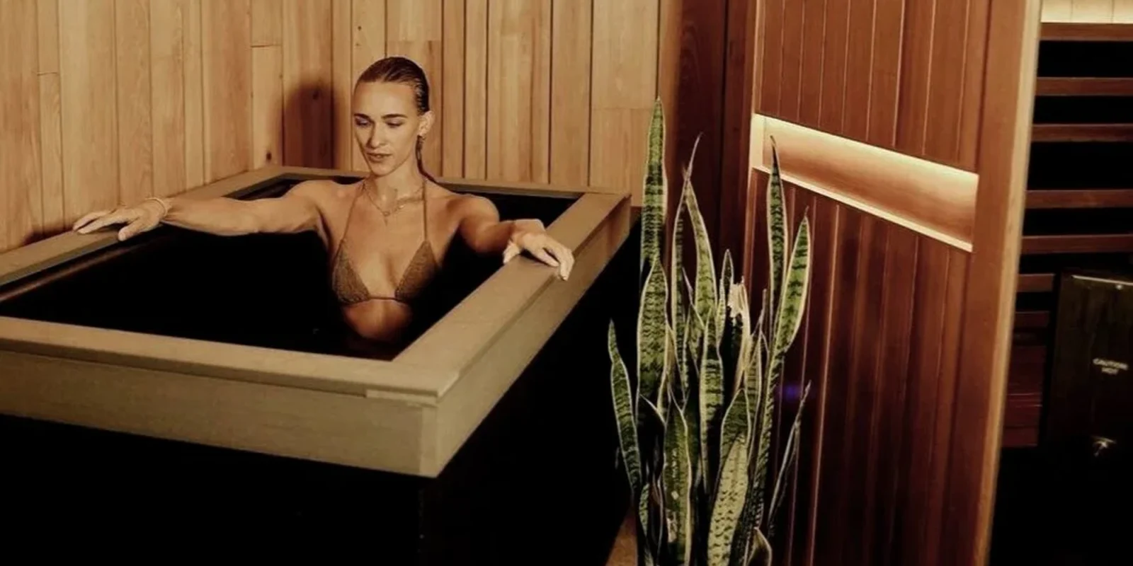 a woman sitting in a Pause Studio tub