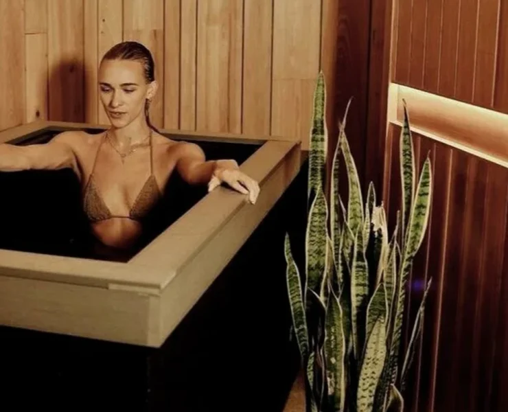 a woman sitting in a Pause Studio tub