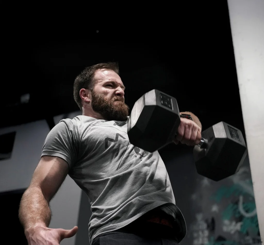 man lifts a dumbbell