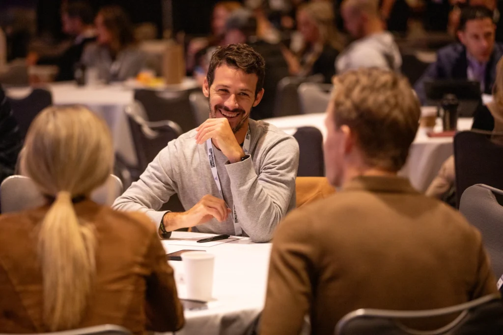 men and women talk at a fitness conference