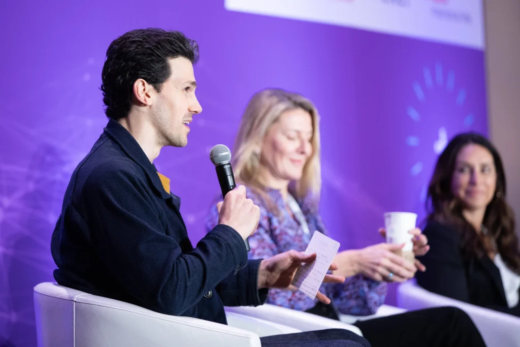 man and two women speak on stage at a fitness conference