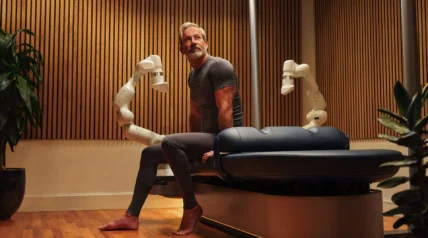 Man sitting on robotic massage table