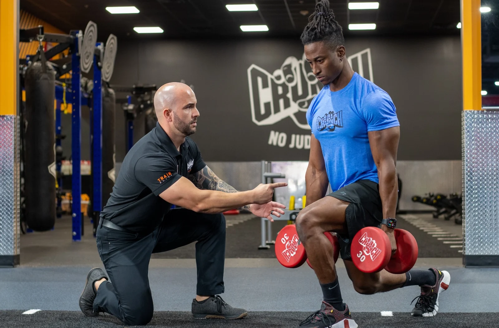 man works out at Crunch Fitness during a personal training session