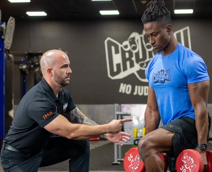 man works out at Crunch Fitness during a personal training session