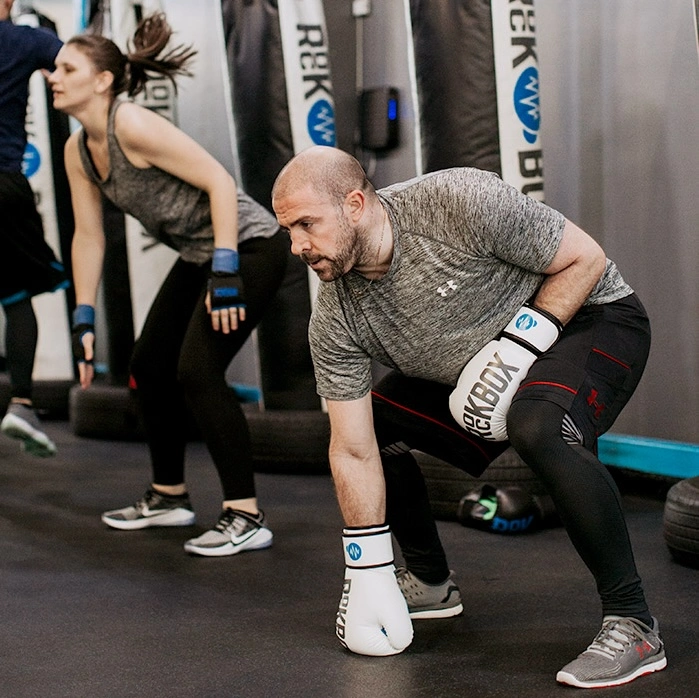 man and woman work out at a RockBox location