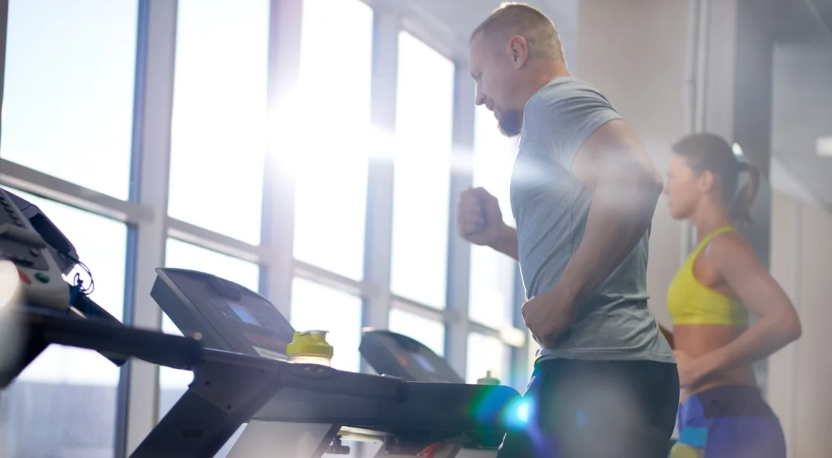 man and woman on treadmills
