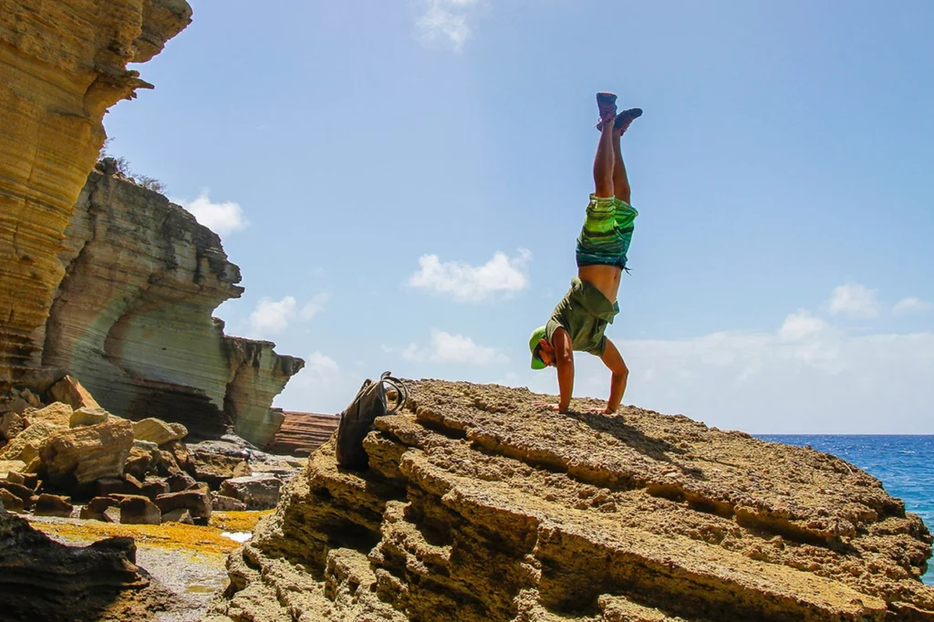 a man doing a headstand outside