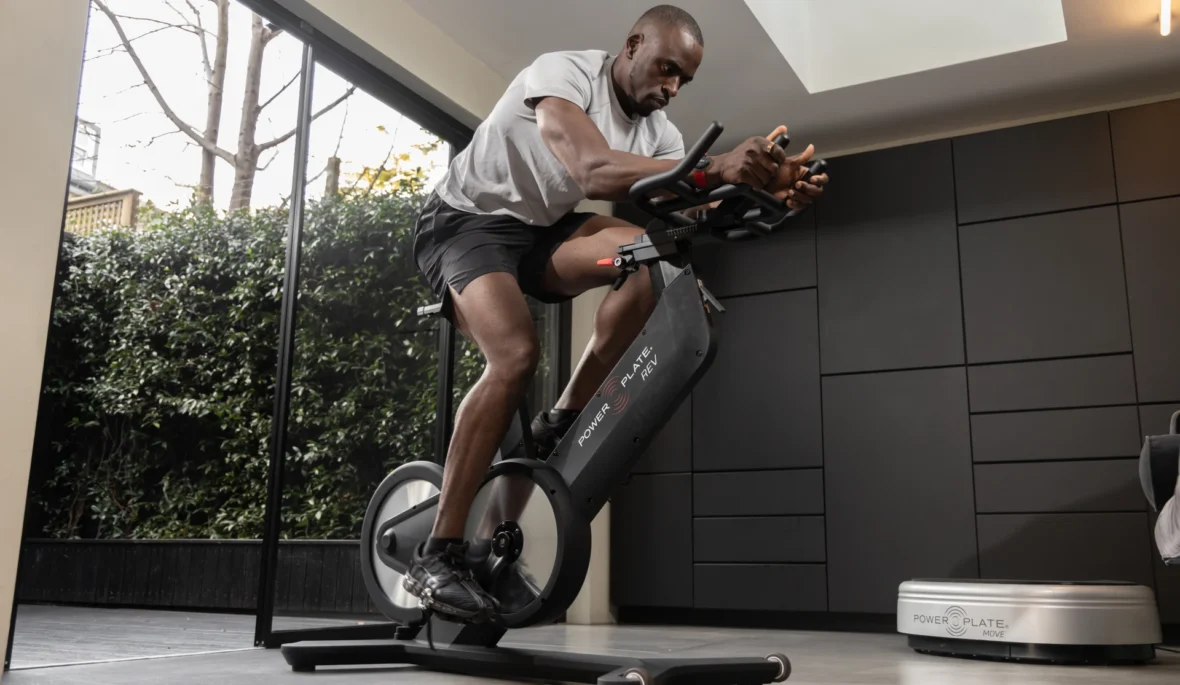 Black man on Power Plate Rev bike