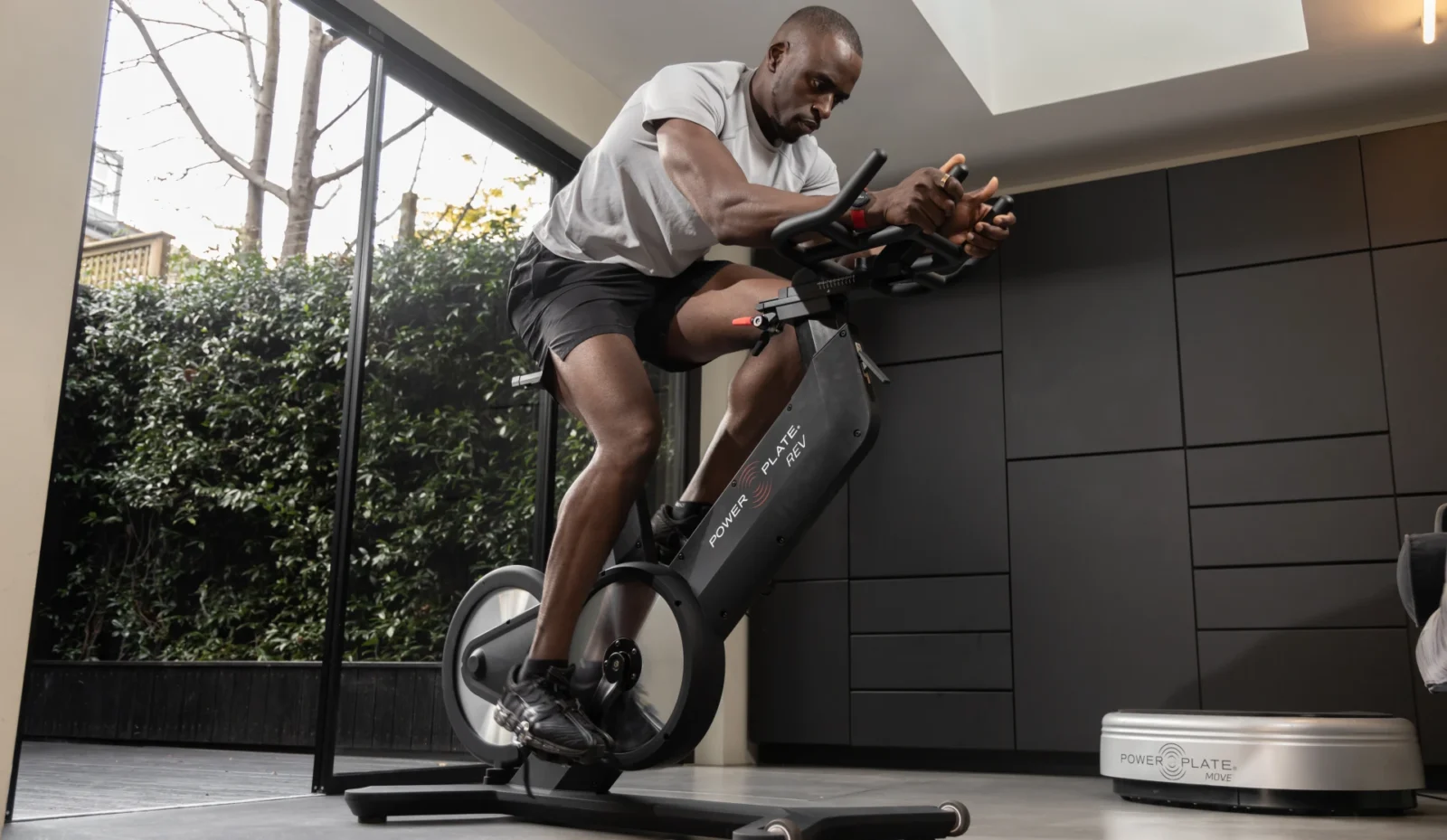 Black man on Power Plate Rev bike