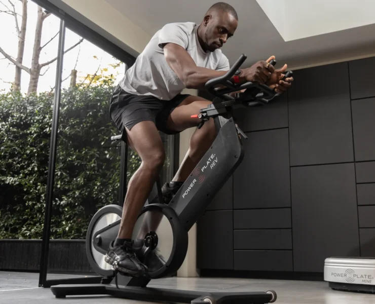 Black man on Power Plate Rev bike