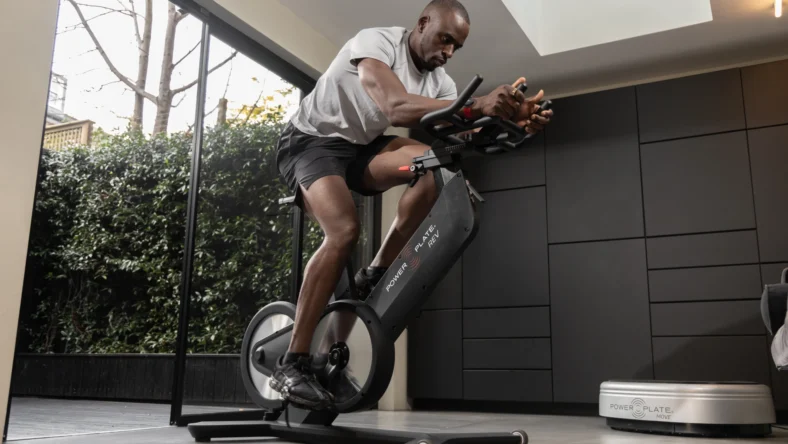 Black man on Power Plate Rev bike