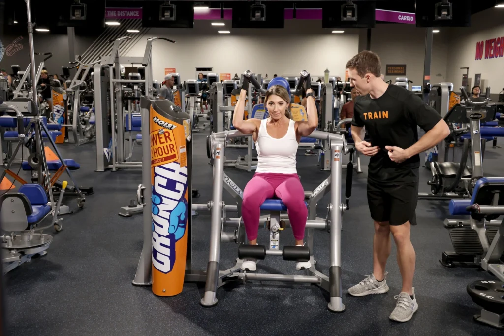 woman works out on a strength training machine