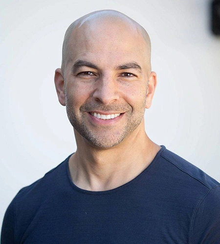 a smiling headshot of Dr. Peter Attia