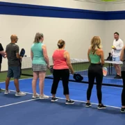 a group of people at PickleRage's pickleball clinic