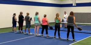 a group of people at PickleRage's pickleball clinic