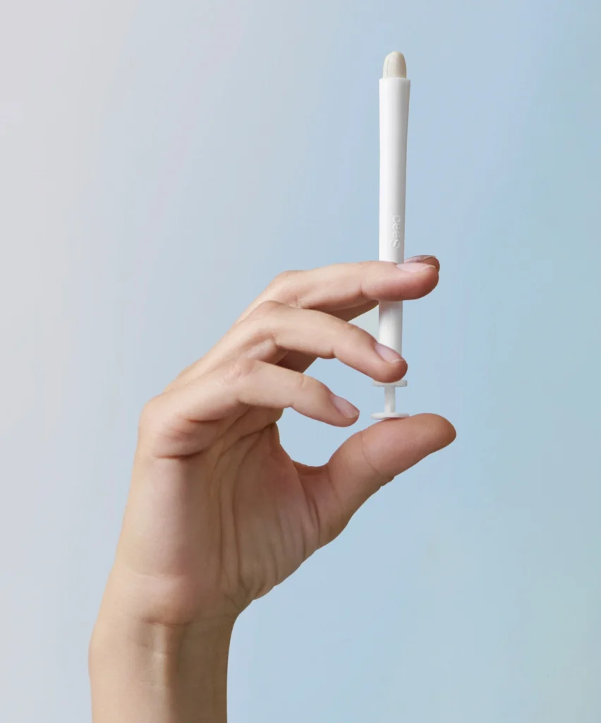 woman holds a vaginal probiotic from Seed